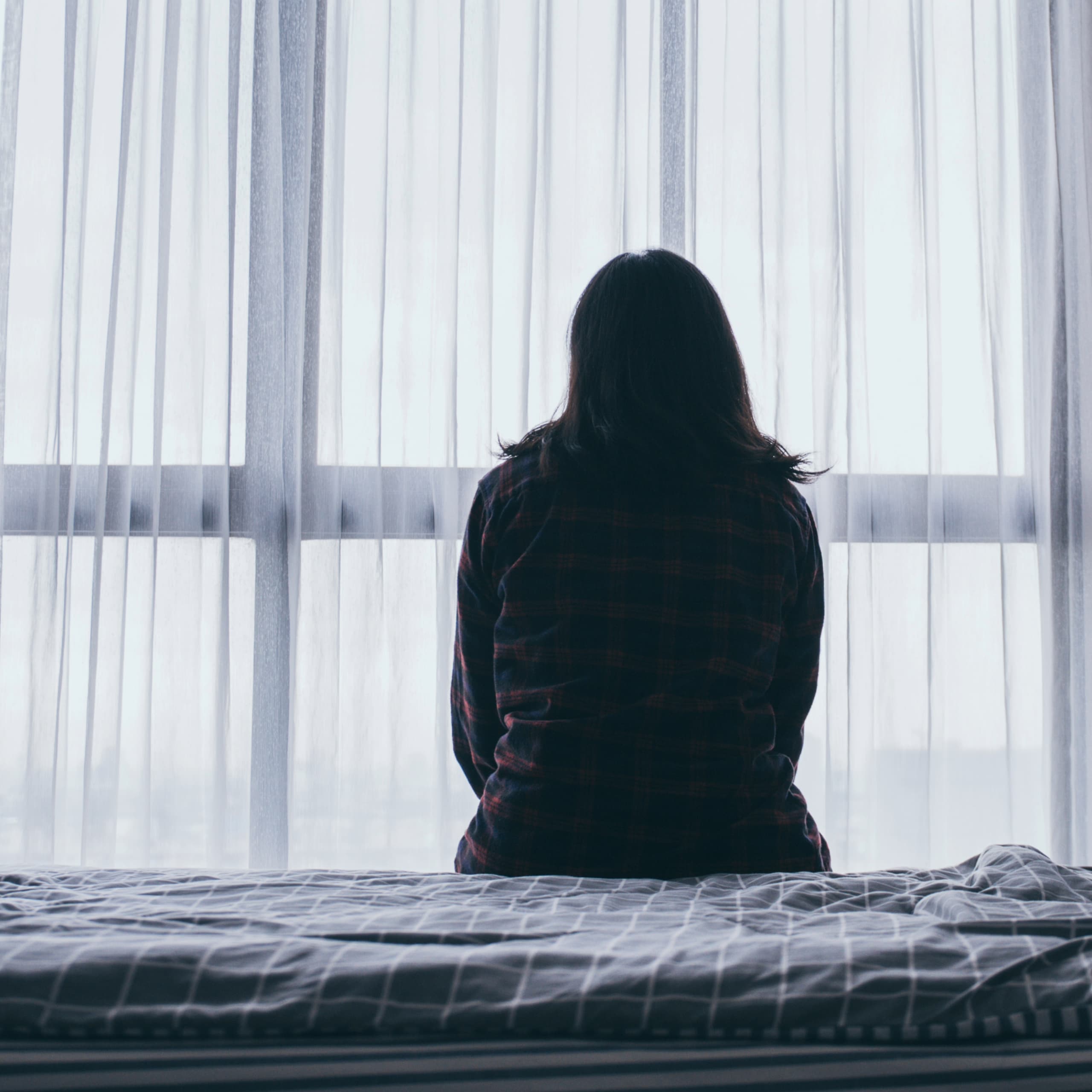 Person quietly reflecting while experiencing emotional exhaustion and hidden depression